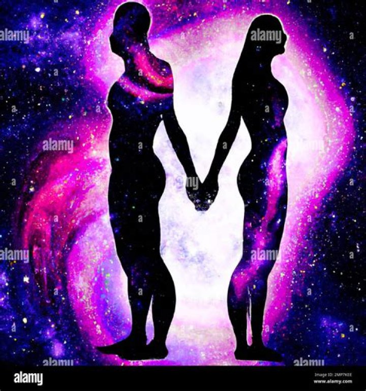 a man and woman in formal wear holding hands
