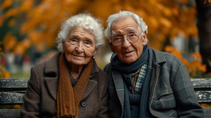 an older man and woman are posing for the camera