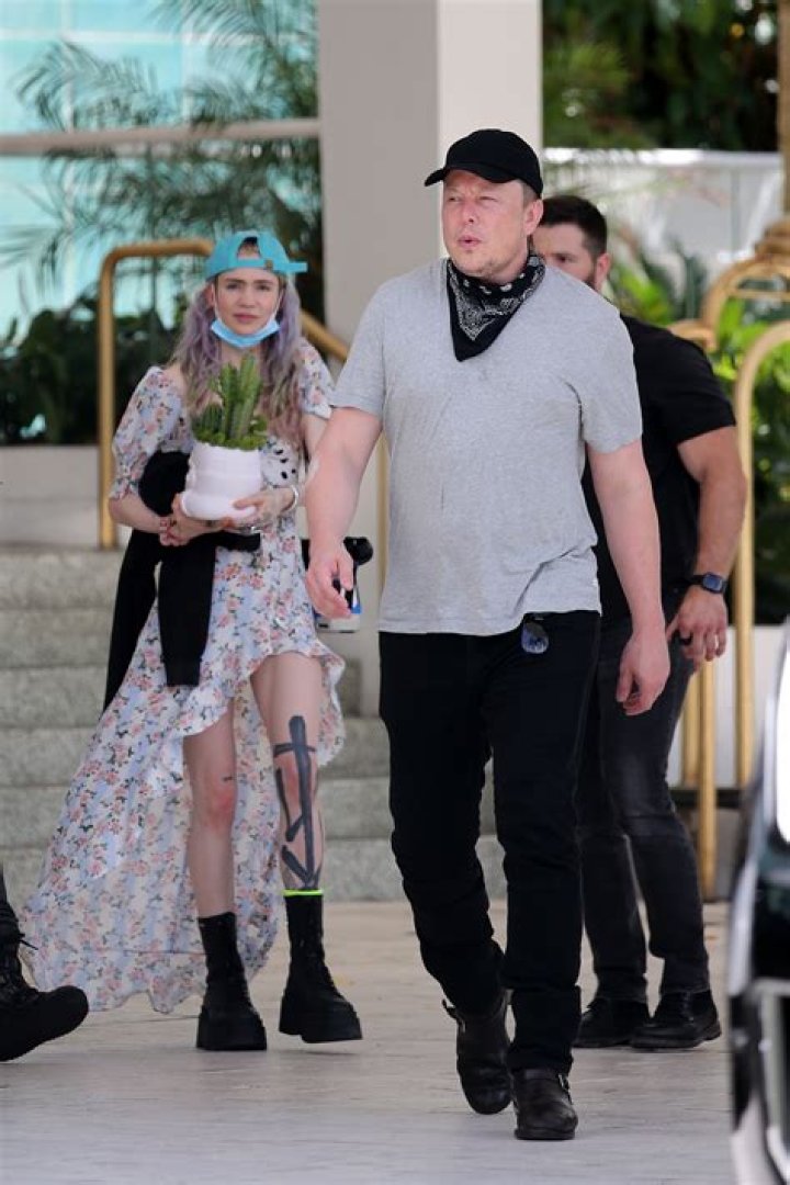 Elon Musk carries baby son 'X Æ A12' as billionaire dad leaves Miami