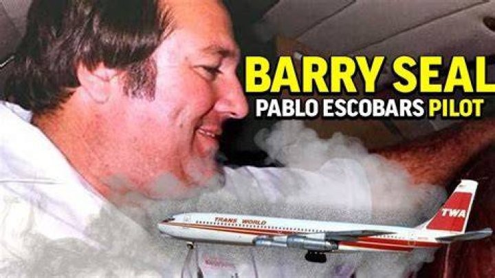 Image of Barry Seal two sons watching him while performing a wheelie on a motorbike near