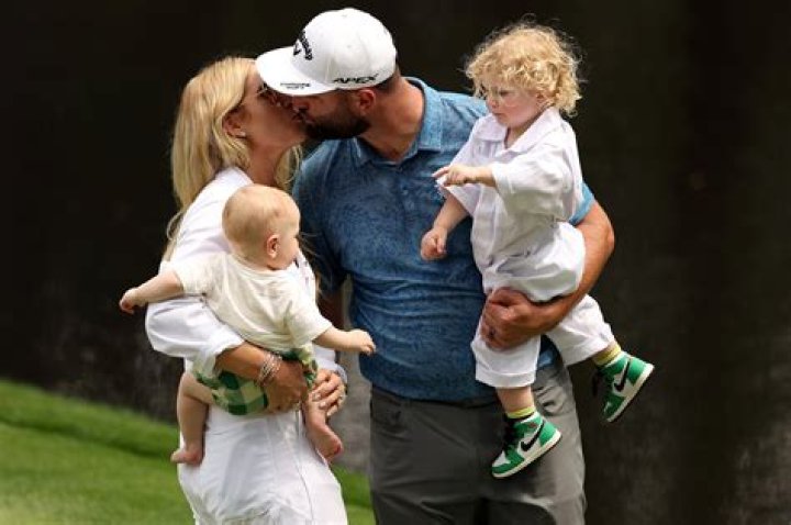 Jon Rahm kisses wife Kelley Cahill after winning 2023 Masters