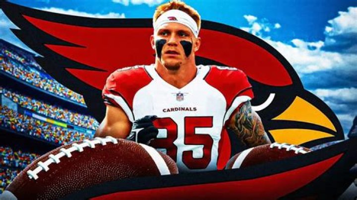 Photo: Trey McBride in Cardinals gear with Cardinals logo and fans behind him