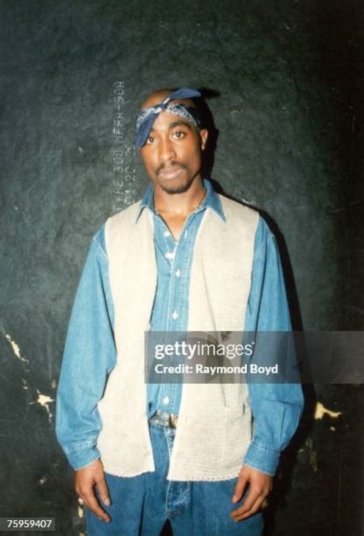 Rapper Tupac Shakur poses for photos backstage after his performance