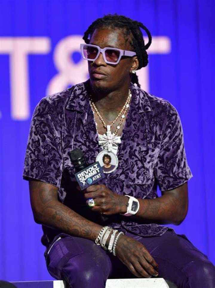 Young Thug posing in the car