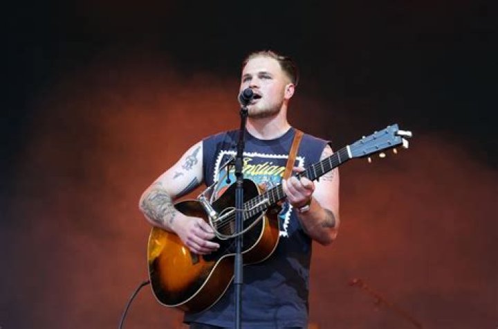 Zach Bryan Responds To Fan Complaints About Merch Prices ‘I’m Fixing